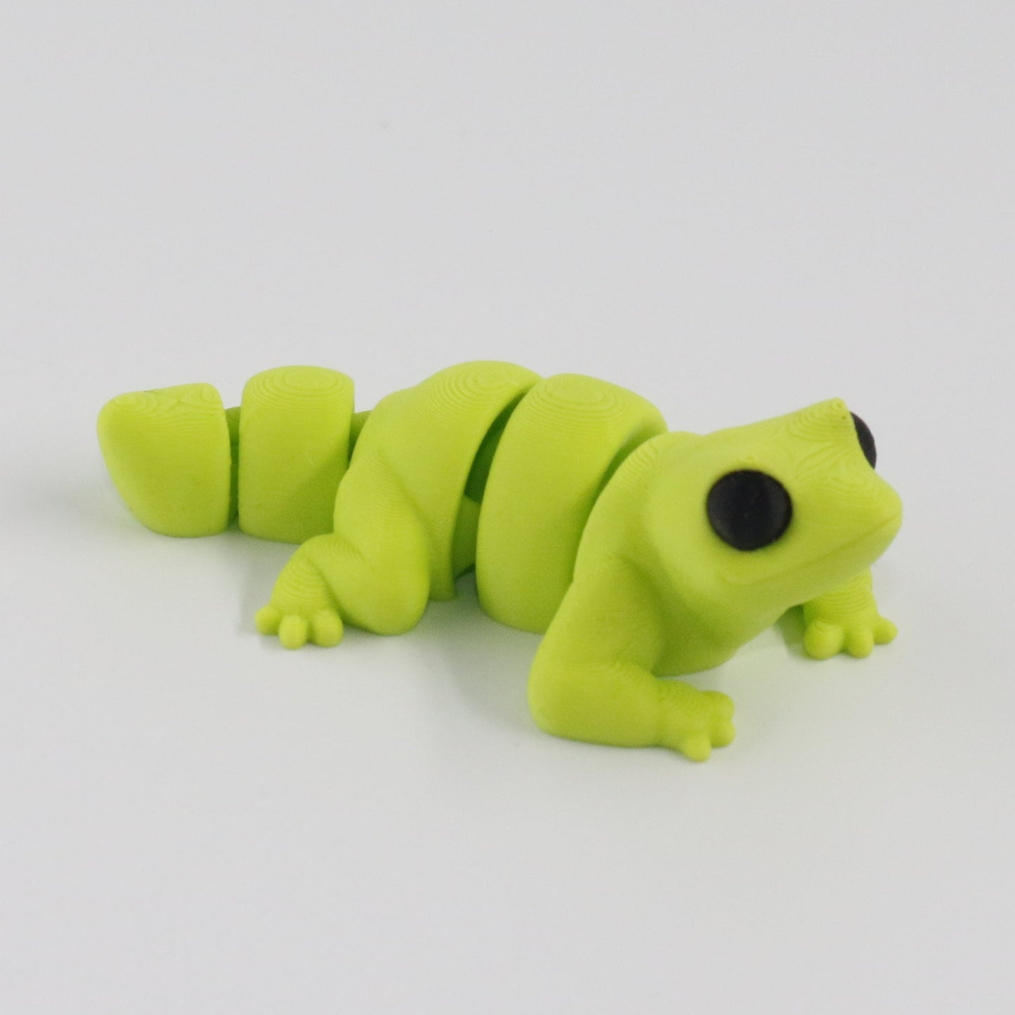 Green lizard toy on a white background