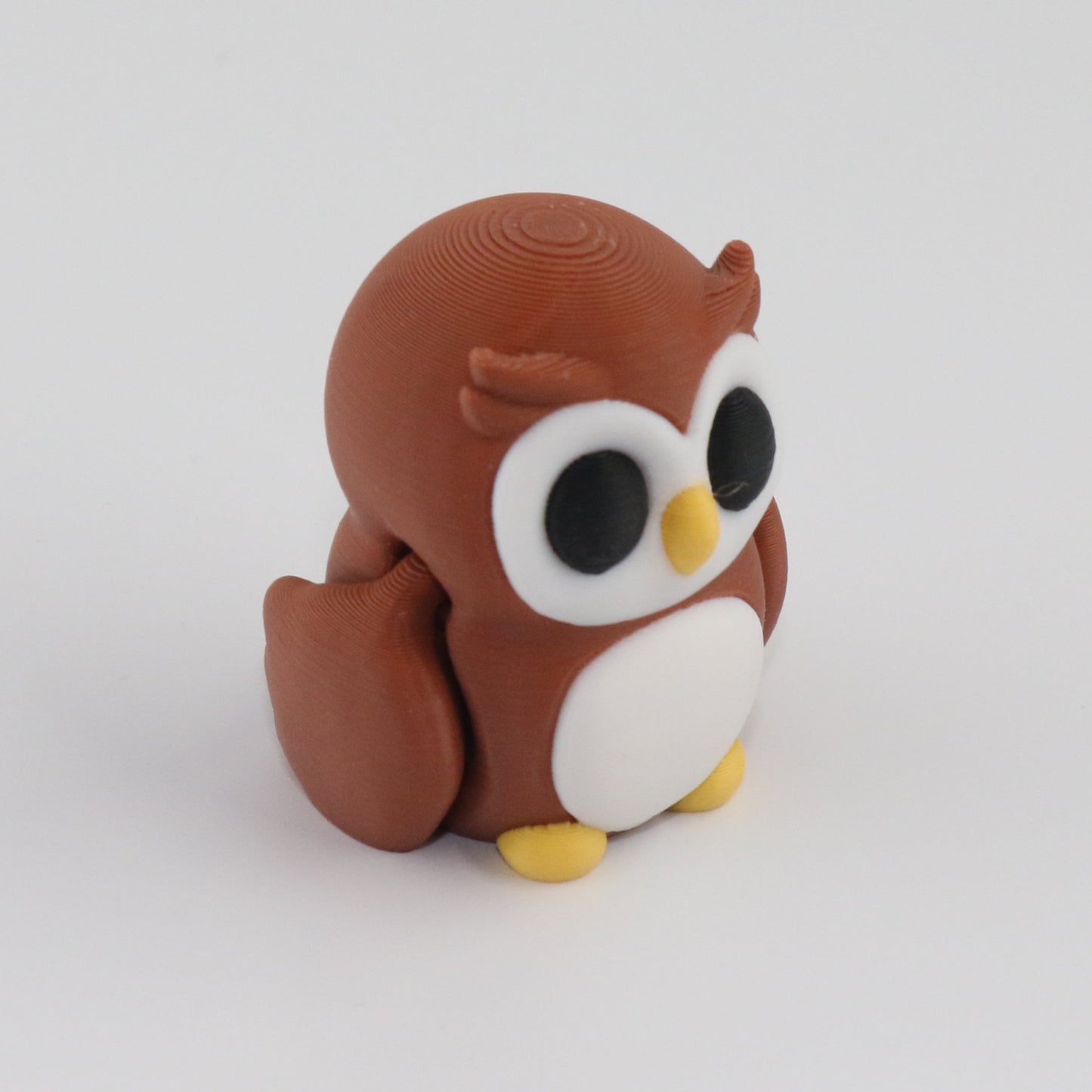 Small owl figurine on a white background