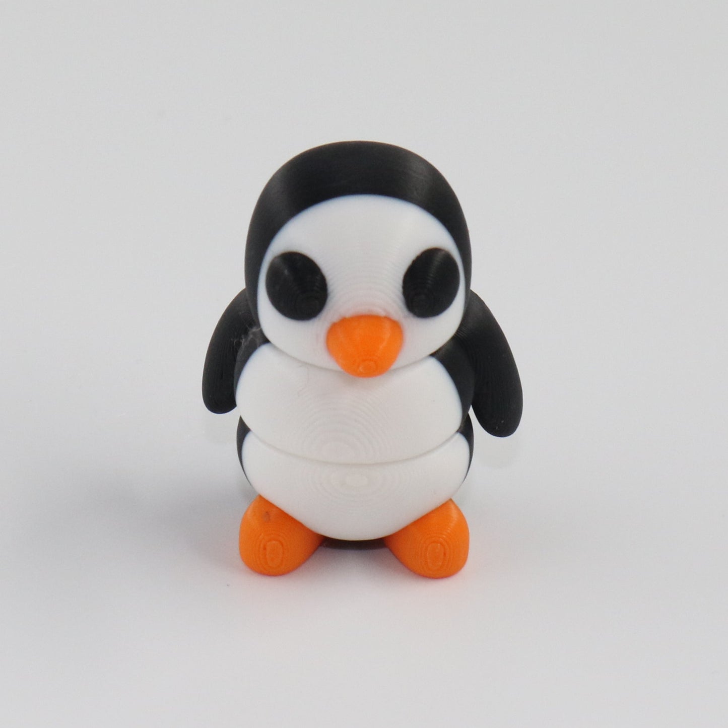 Small penguin figurine on a white background