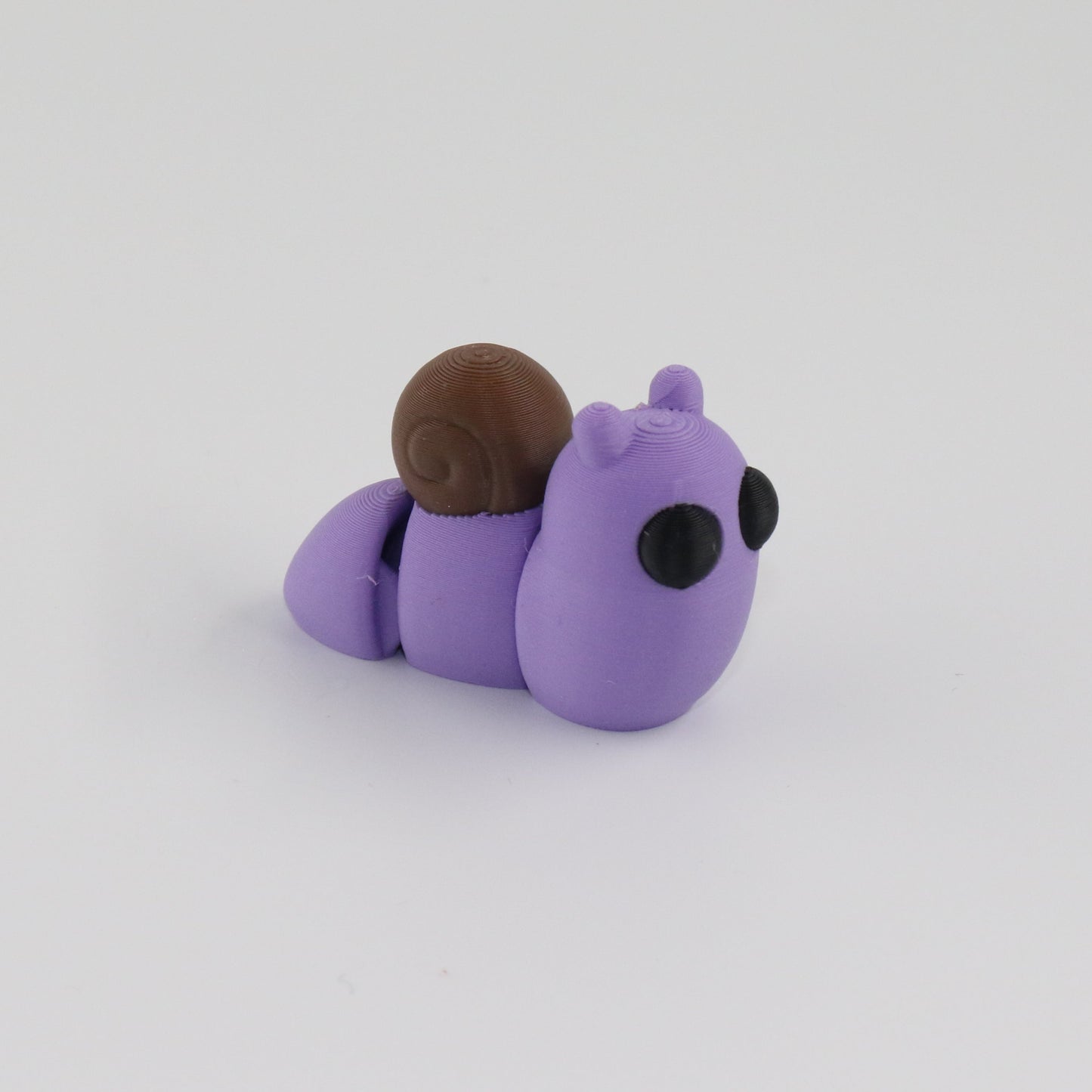 Purple snail toy on a white background