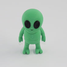 Green alien toy on a white background