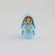 Small figurine of a person in a blue outfit on a white background