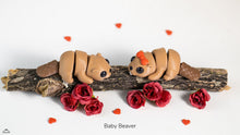 Two baby beavers on a branch with red flowers and heart-shaped petals on a white background