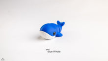 Blue whale toy on a white background