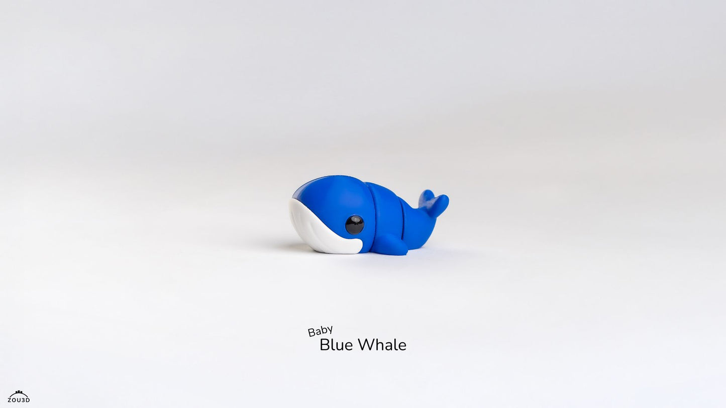 Blue and white whale toy on a light gray background