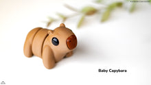 Small figurine of a baby capybara on a white background with 'Baby Capybara' text.