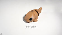 Toy catfish on a white background with 'Baby Catfish' text.