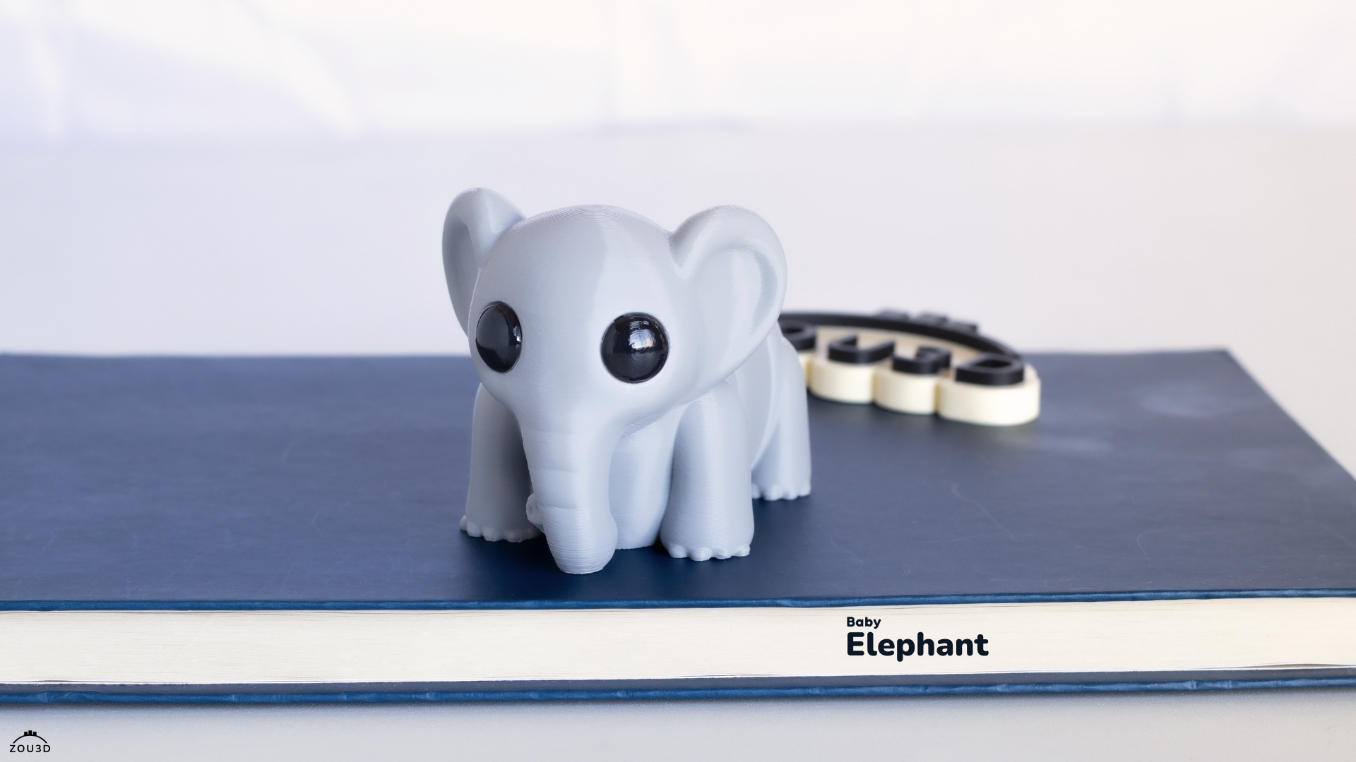 3D-printed elephant model on a blue surface with 'Replicatr' branding.