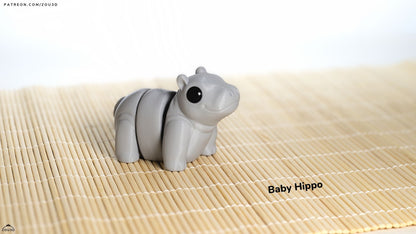 Gray hippo-shaped object on a bamboo mat with 'Baby Hippo' text