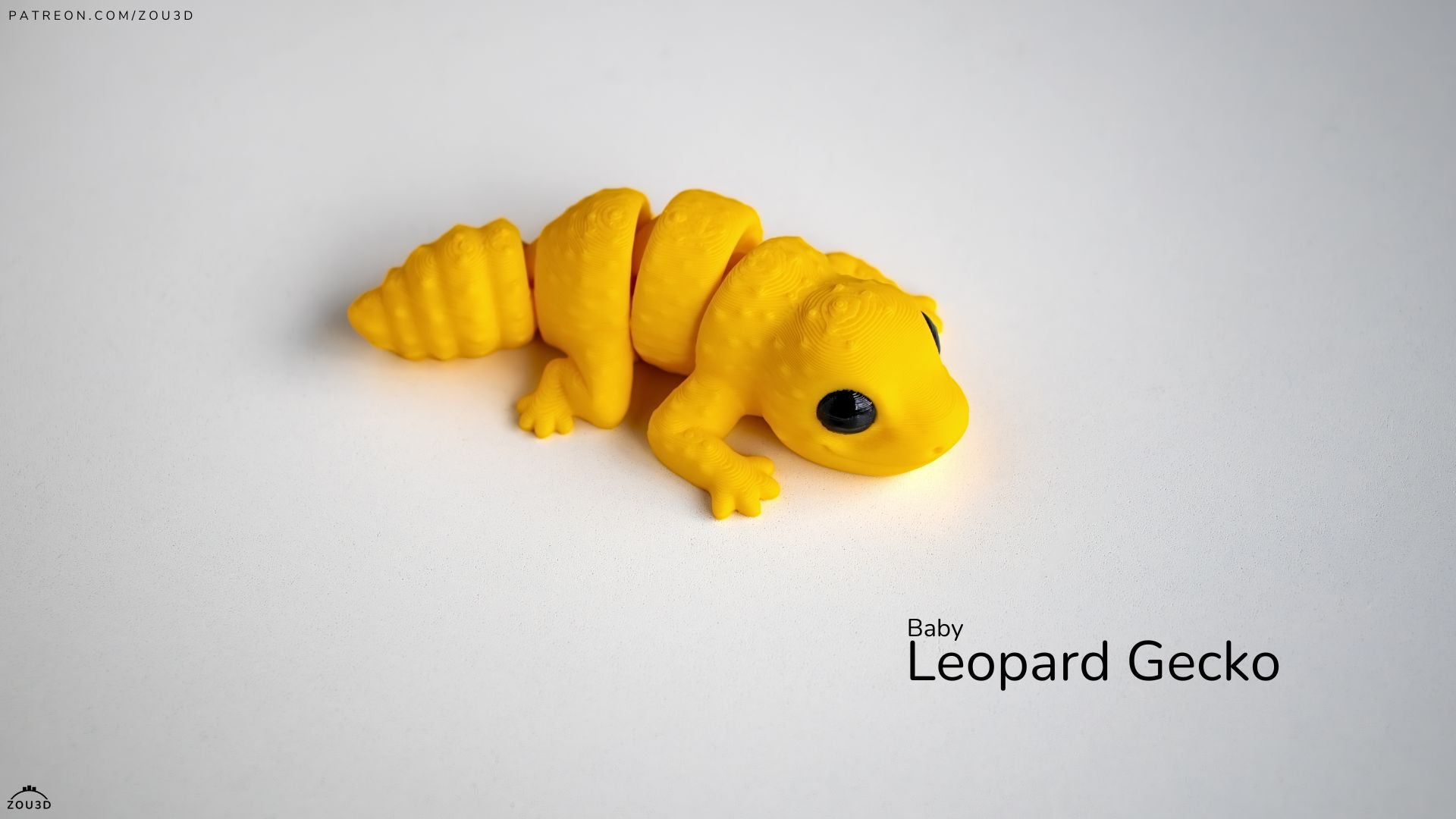 Yellow toy baby leopard gecko on a white background