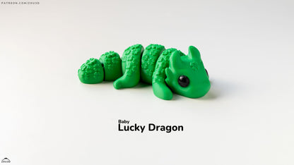 Green dragon toy with 'Baby Lucky Dragon' text on a white background