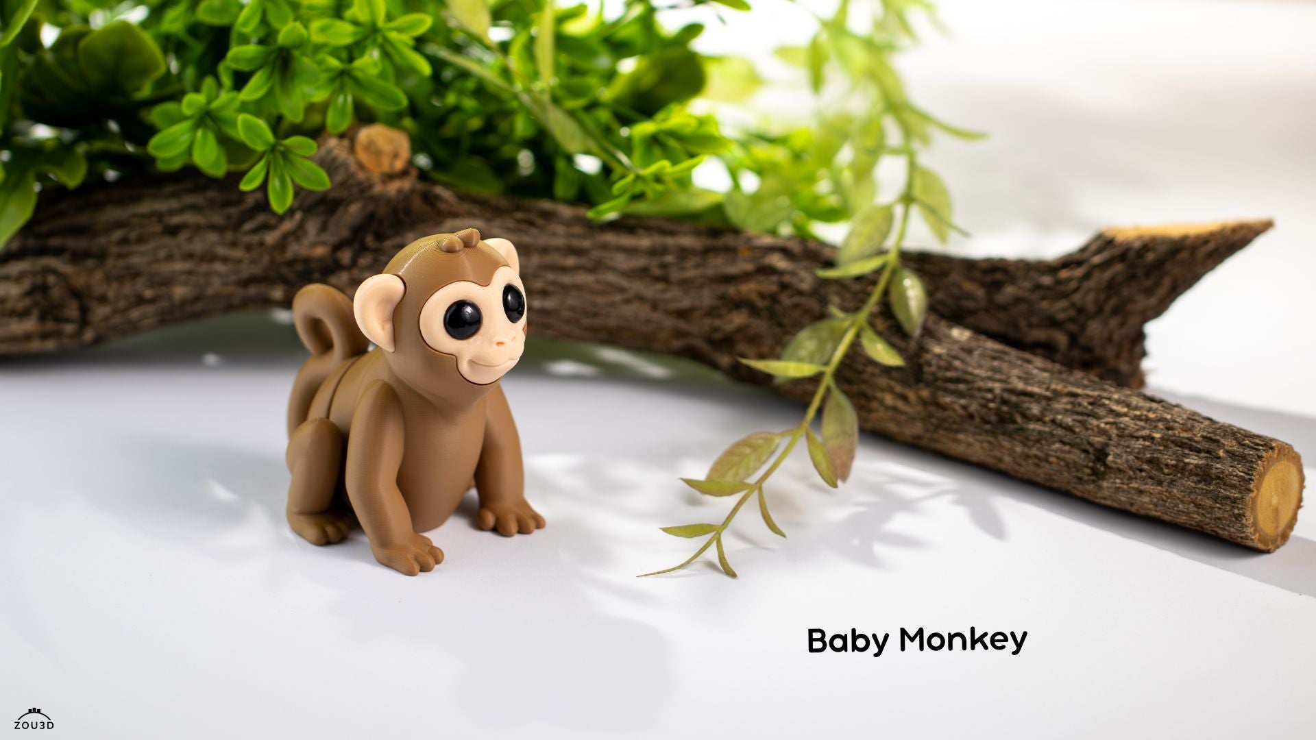 Toy monkey figure on a white surface with greenery
