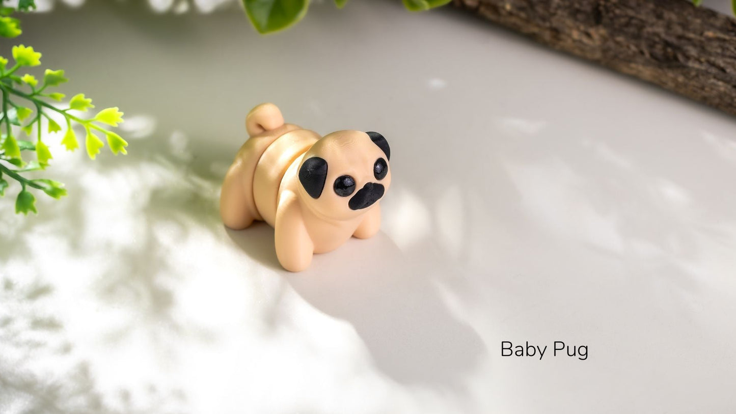 Small figurine of a baby pug on a light surface with greenery in the background
