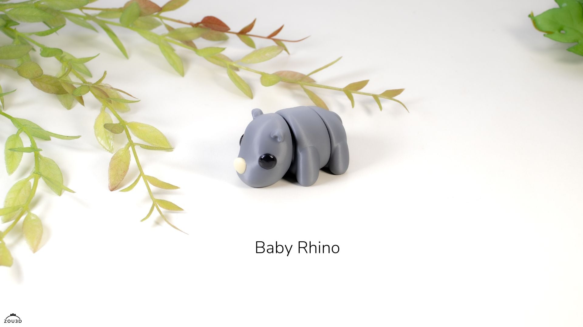 Model of a baby rhino on a white background with green leaves