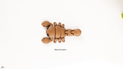 Articualted toy resembling a baby scorpion on a white background