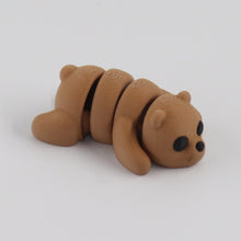 Small brown bear figurine on a white background