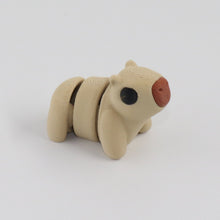 Small beige capybara on a white background