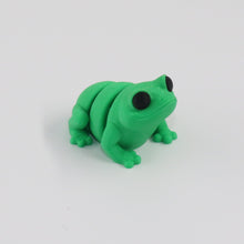 Green frog toy on a white background