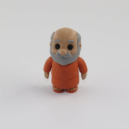 Small figurine of an elderly man in a brown outfit on a white background