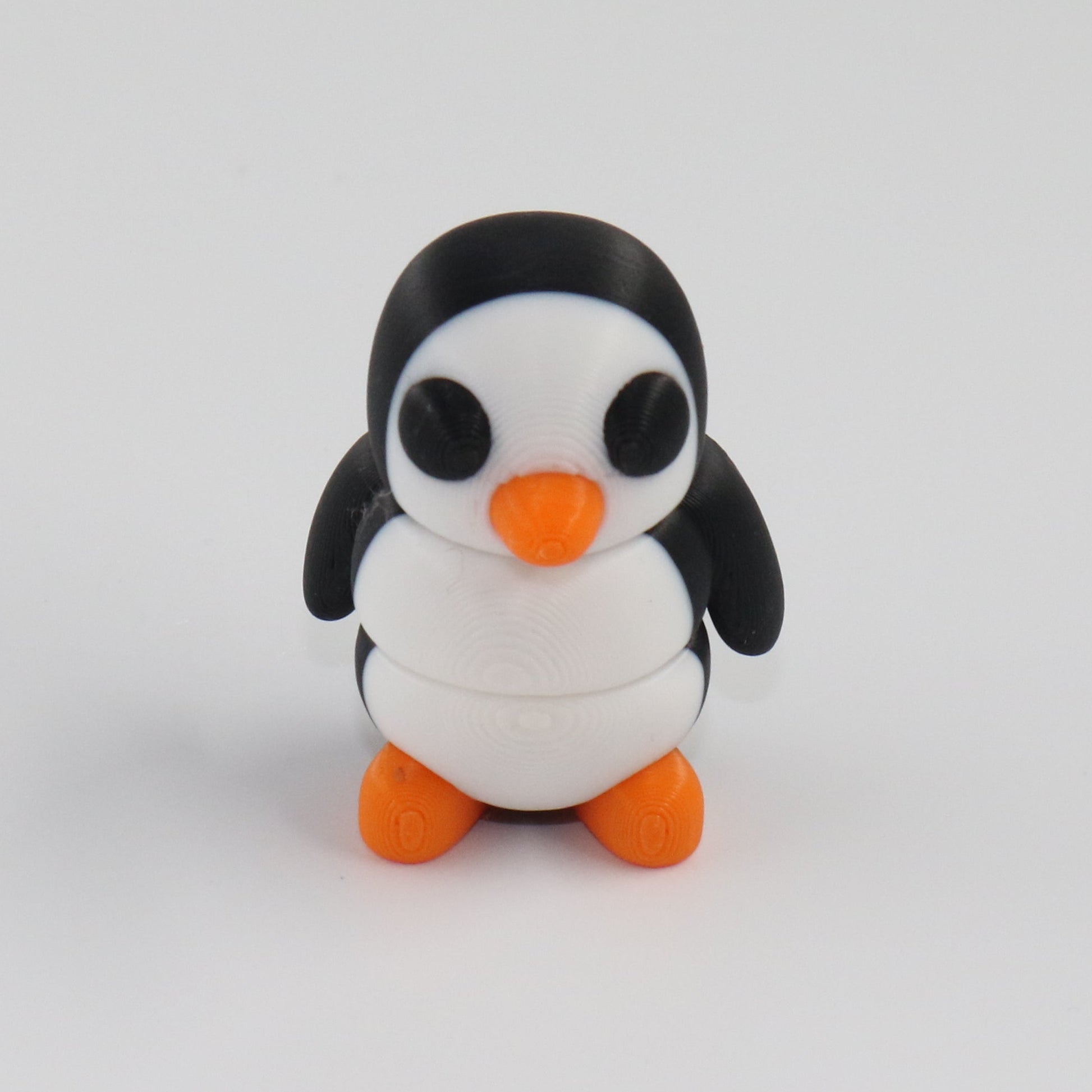 Small penguin figurine on a white background