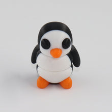 Small penguin figurine on a white background
