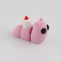 Small pink snail toy figure on a light gray background