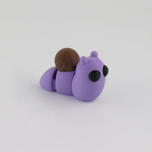 Purple snail toy on a white background