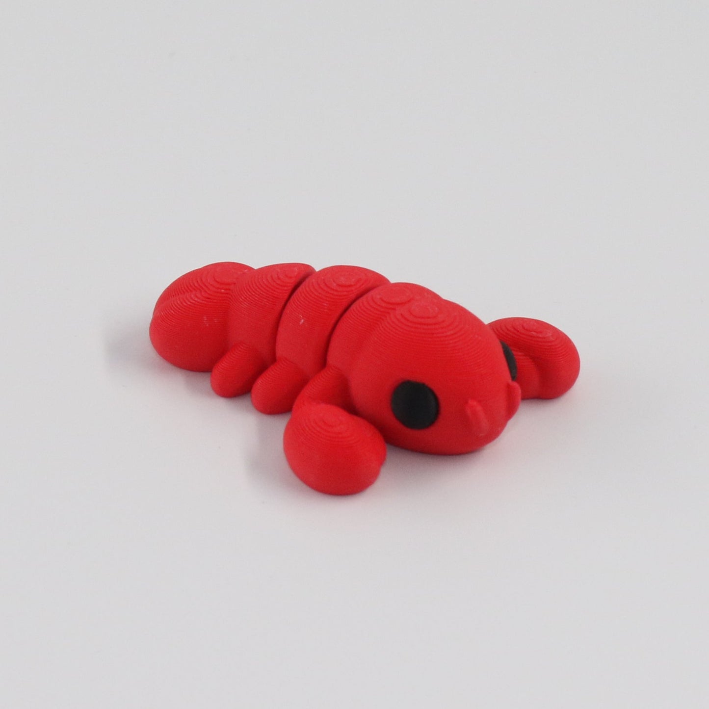 Red toy lobster on a white background