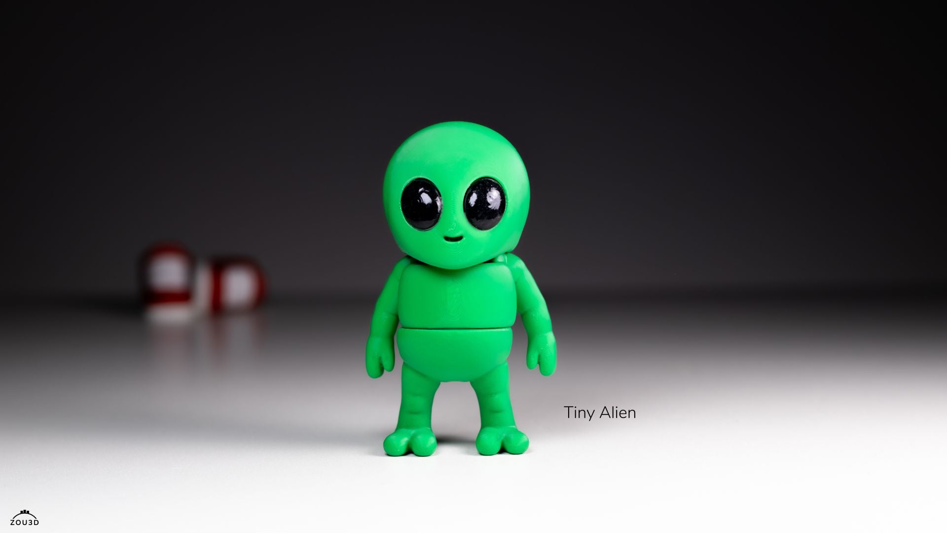 Green alien figurine with a dark background