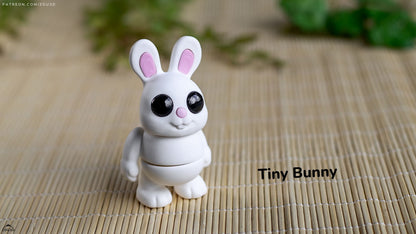 White bunny figurine with pink ears on a woven mat background