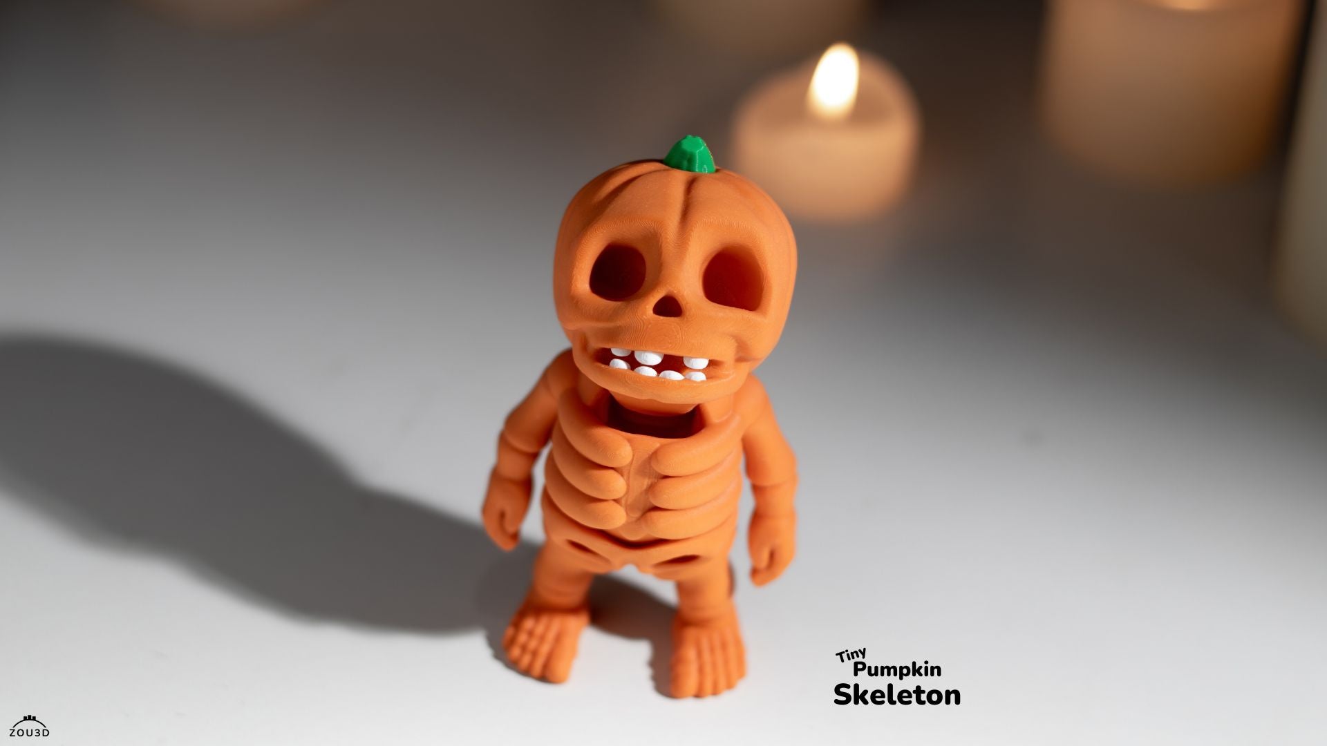 Pumpkin skeleton toy with a blurred candle in the background