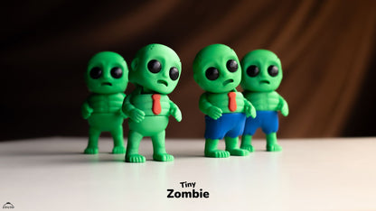 Four green zombie figurines with different expressions on a white surface.