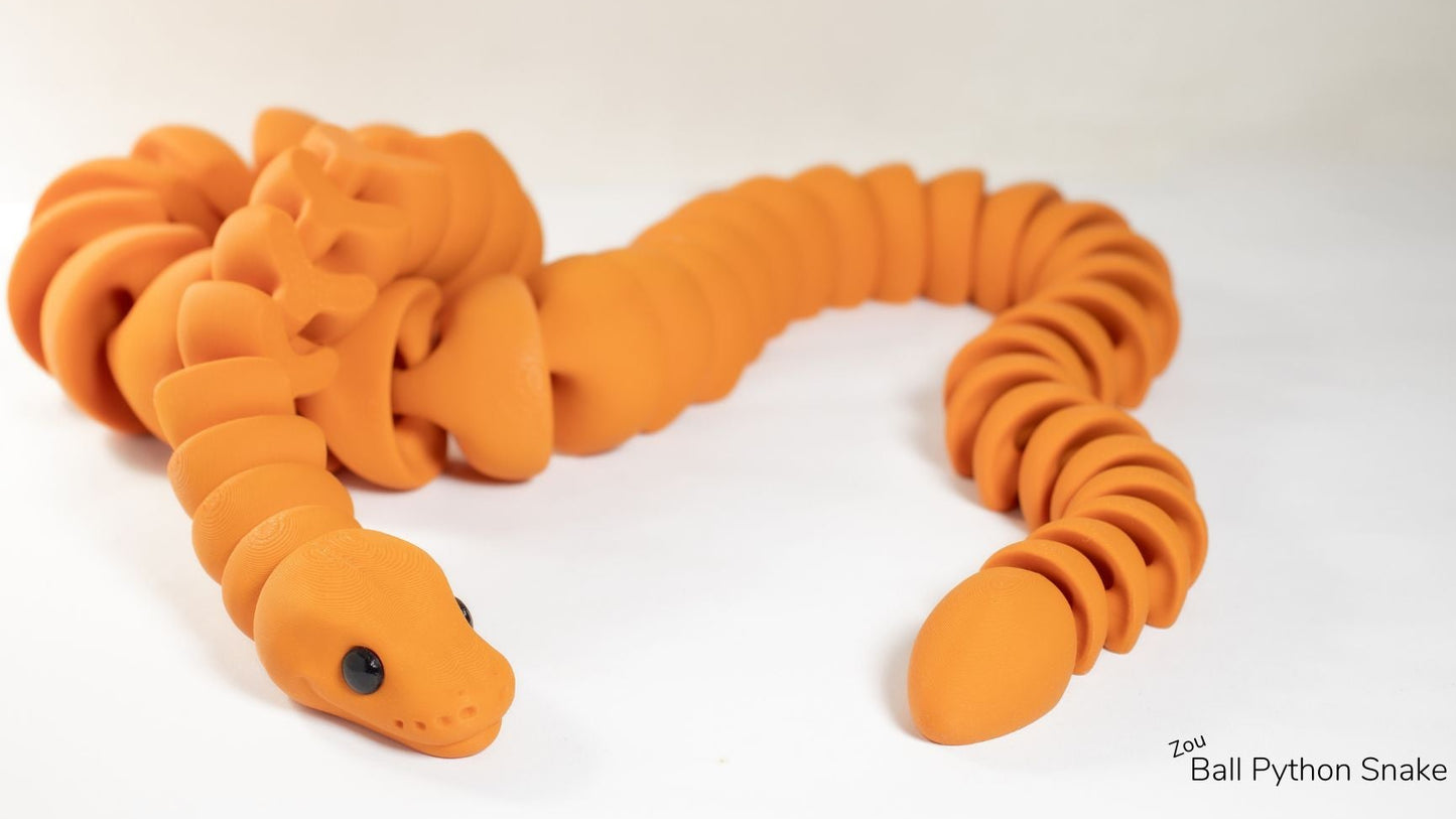 Orange toy snake on a white background