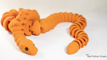 Orange toy snake on a white background
