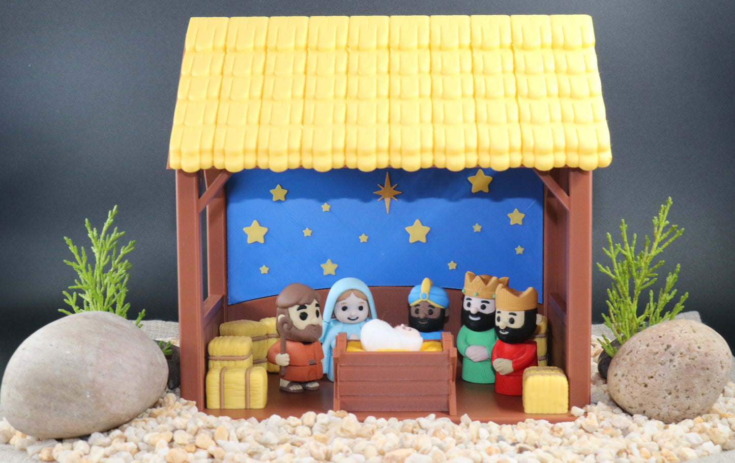 Nativity scene model with stable and figures on a dark background