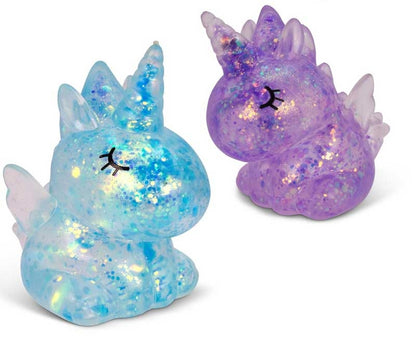 Two glittery unicorn figurines, one blue and one purple, on a white background.