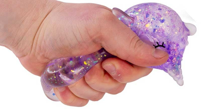 Hand holding a glittery purple squishy toy with a white background