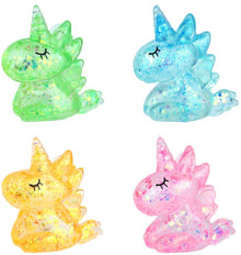 Four colorful glittery dragon figurines on a white background
